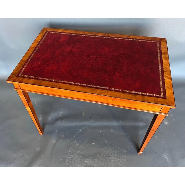 19th-century English Edwardian period satinwood and leather top table. Very pretty color and the smaller scale makes it a...