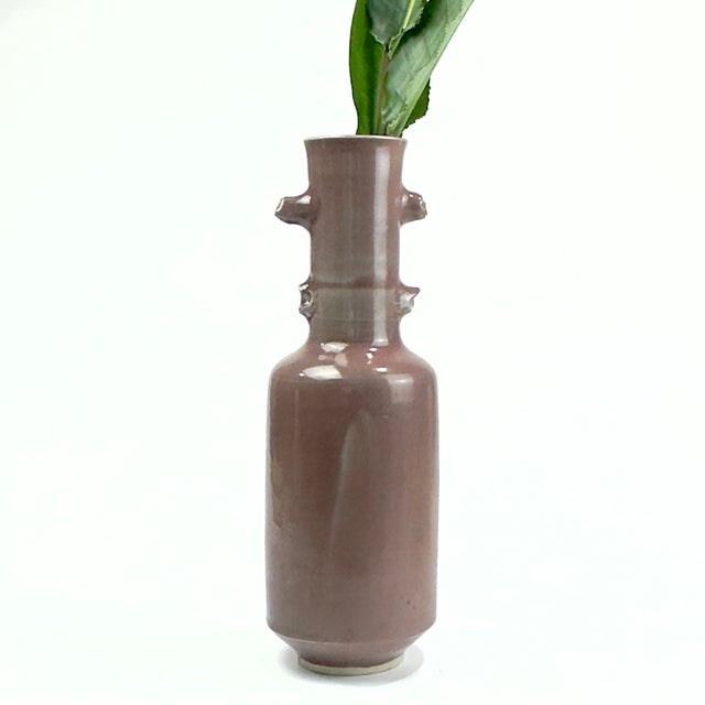 Add a touch of sculptural elegance to your home with this striking vintage studio pottery vase signed by renowned...