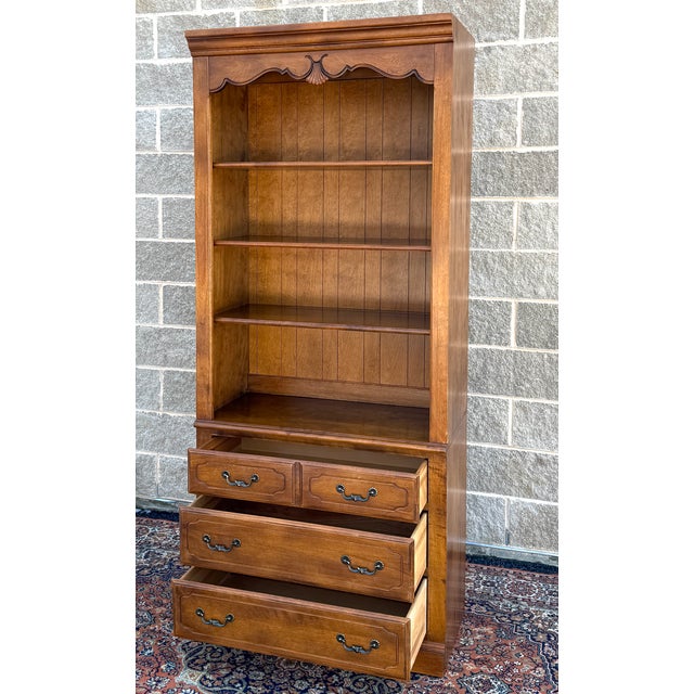 A late 20th century Ethan Allen Country French collection solid birch 2 piece wall unit consisting of a 3 drawer chest and...