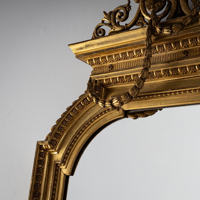 Large and ornate wall mirror from the second half of the 19th century, crafted in the Louis XVI style. The gilded frame...