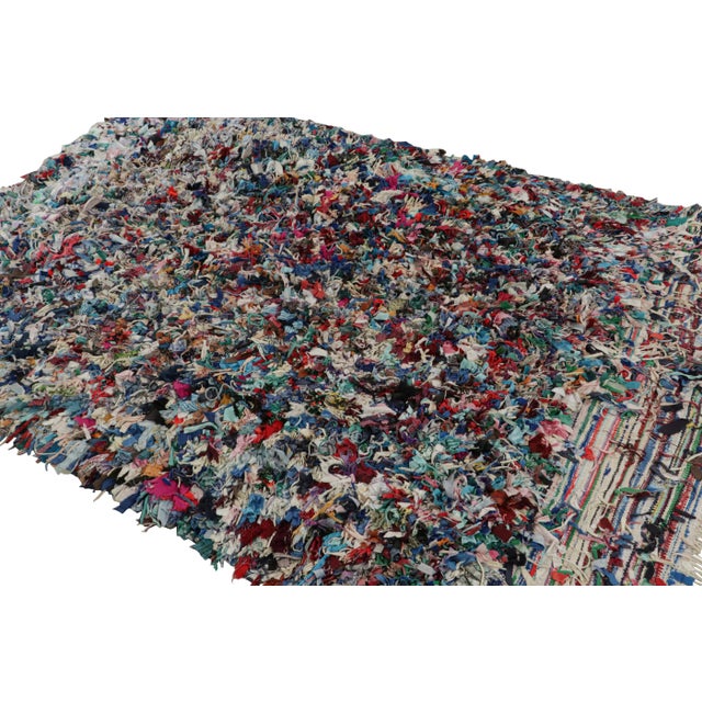 Hand-knotted in fabric circa 1950-1960, this vintage 7x9 Moroccan Boucherouite rug is believed to hail from the Azilal...