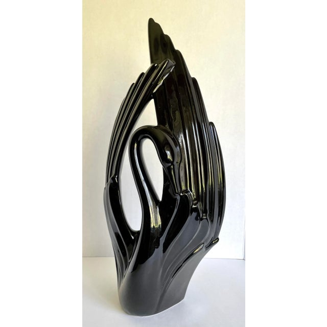 Here is a stunning ceramic sculptural piece made by Royal Haeger in the 1960's. The piece features a swan with it's wings...