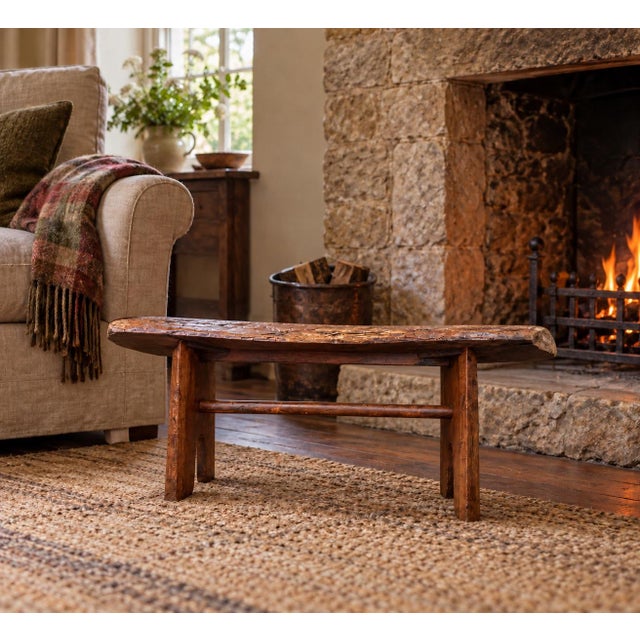 A beautifully handcrafted live-edge bench featuring a solid hardwood slab seat with natural contours, knots, and rich...