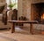 A beautifully handcrafted live-edge bench featuring a solid hardwood slab seat with natural contours, knots, and rich...