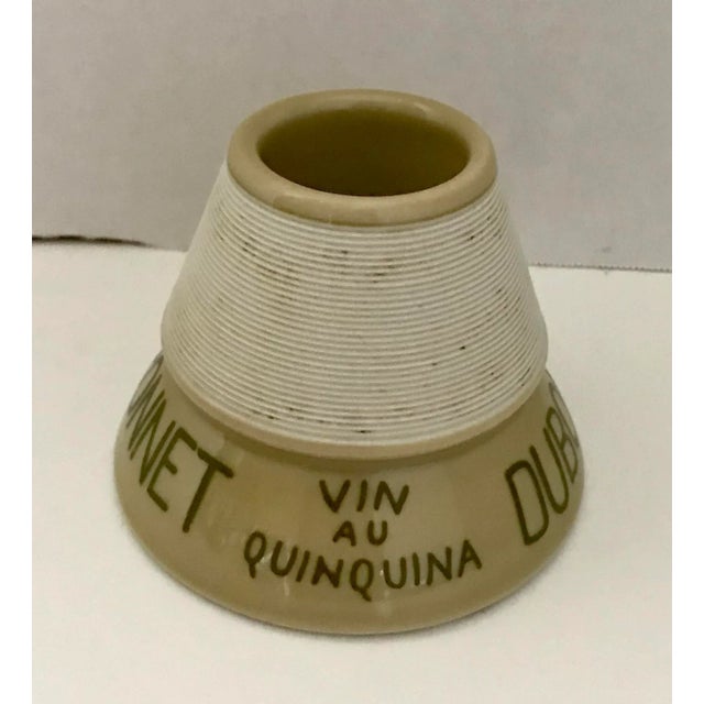 Here is a lovely Parisian café match striker and keeper. It was made to advertise Dubonnet and the Grand Prix of 1900. The...