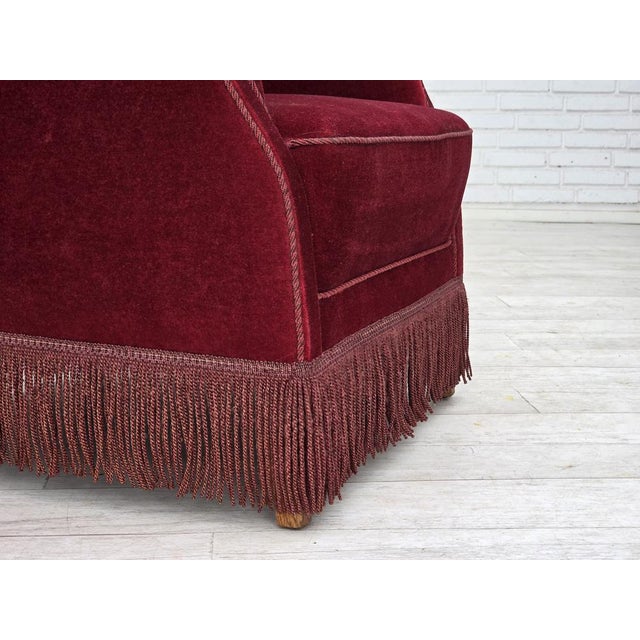 1970s, Danish armchair. Cherry-red furniture velour, oak wood legs, springs in the seat. Original good condition: no...