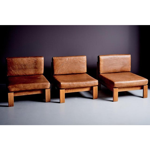 These modular lounge chairs feature solid oak frames with clean, rectilinear lines, paired with generously upholstered...
