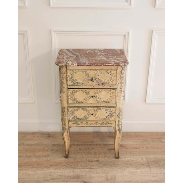 A charming French half chest of drawers dating to the nineteenth century, executed in the Transition style that bridges...