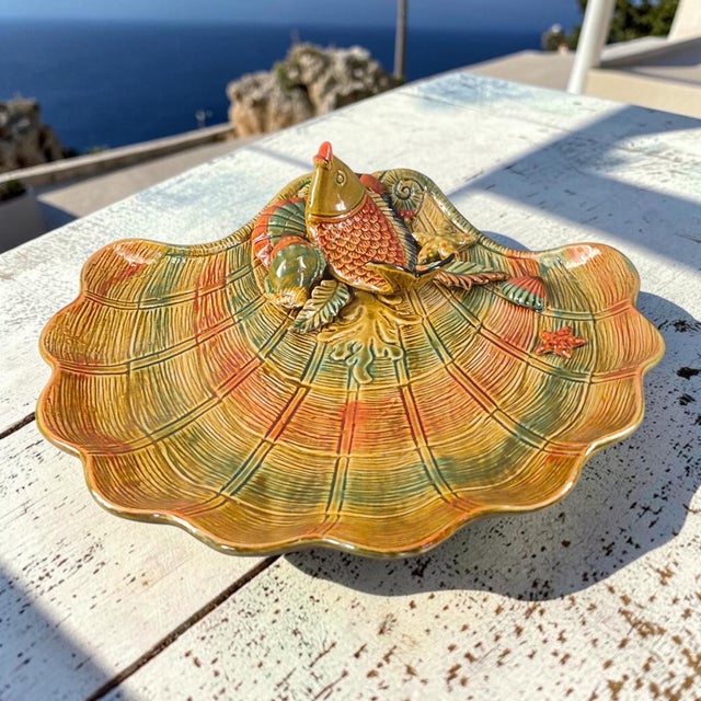 This ceramic Majolica seashell shaped fish serving platter is an original piece from Italy. The multicolor design features...