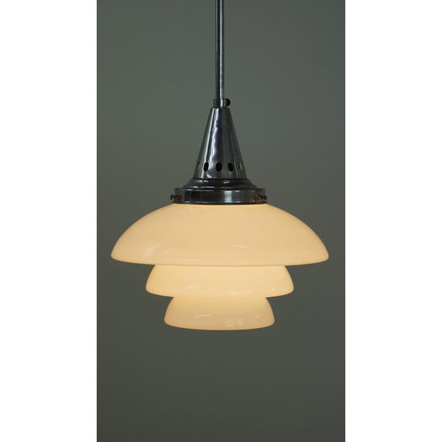 We are offering this vintage design pendant lamp featuring layered frosted glass and chrome. This elegant vintage pendant...