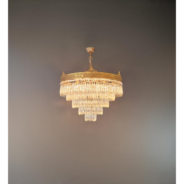 This elegant antique crystal chandelier dates to approximately 1930 and combines Neoclassical ornamentation with the more...