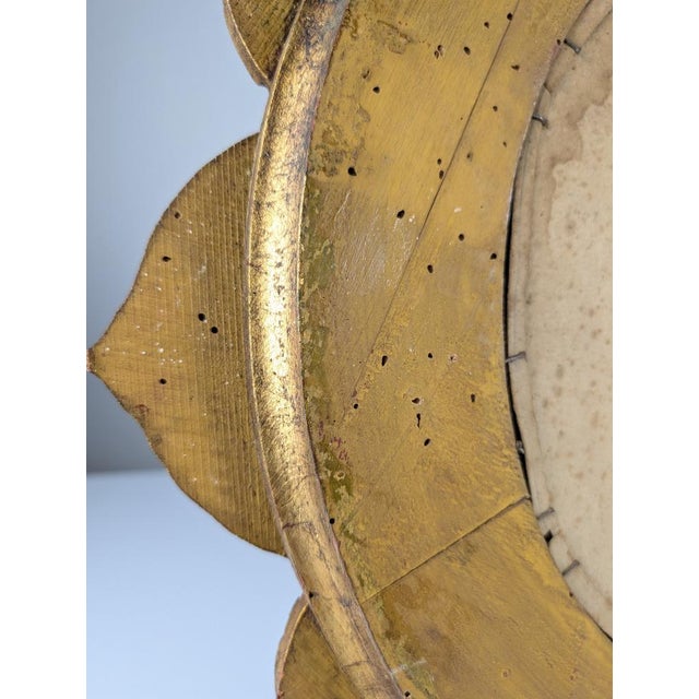 Beautiful mirror from the 1950s carved in wood in the shape of a flower and finished in gold leaf. A highly decorative...