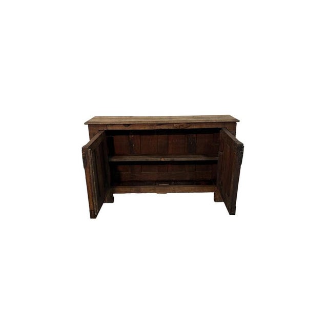 An elegant 18th-century sideboard, crafted from solid chestnut wood and featuring rich decorative workmanship that...