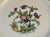 Hand-painted Limoges plates, each featuring a vivid bird and floral motif in rich, layered color. These are authentic...
