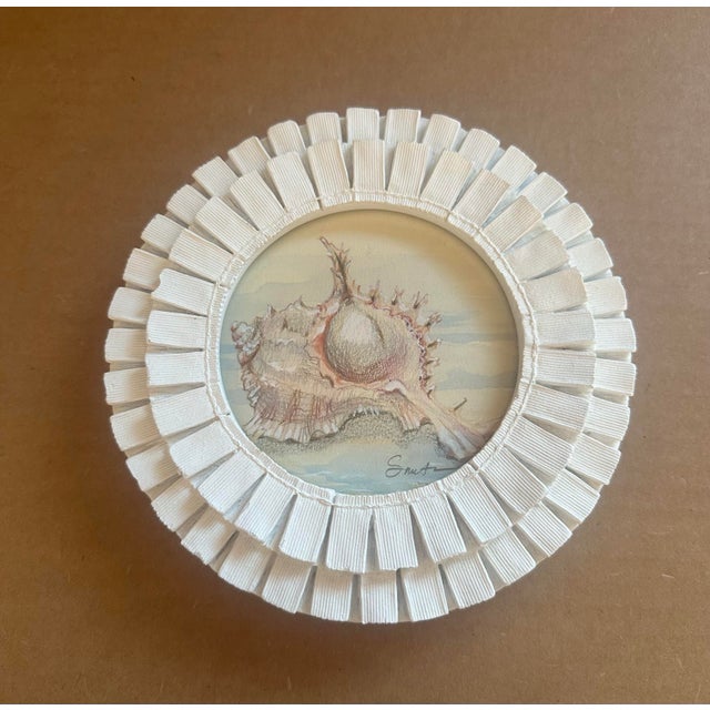 Delightful original vintage seashell painting presented in a unique round frame adorned with sculptural pleated ribbon...