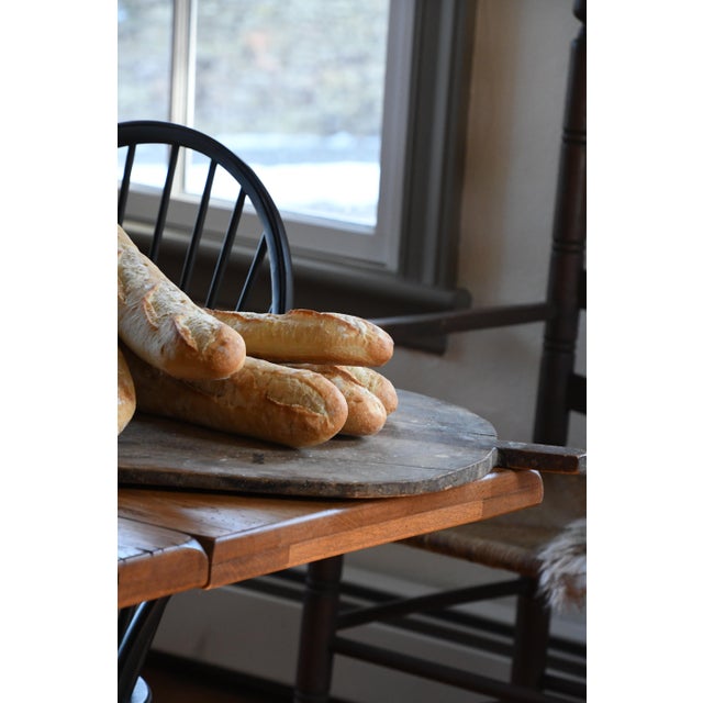An early 20th century antique European breadboard, hand-carved from solid wood and worn beautifully with age. Perfect for...