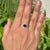 This statement ring showcases a 1.12 carat pear-cut blue sapphire set in 14k yellow gold. The sapphire measuring...