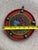 Handcrafted decorative wall hanging OM plaque featuring red, blue, orange and turquoise beads with a central metallic Om...