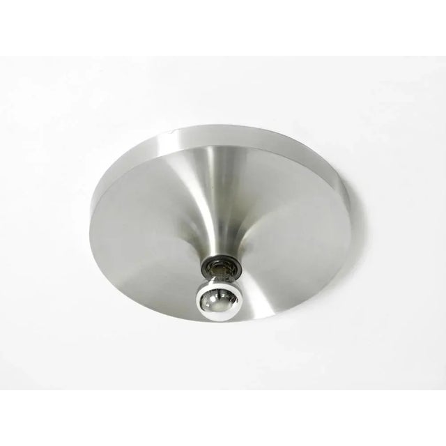 Minimalist large 1960s Space Age Pop Art ceiling or wall lamp made of matte brushed aluminum. Fully functional with an...