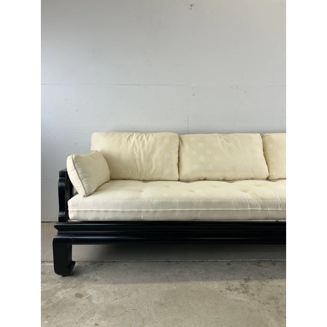 This mid century Chinoiserie Ming Style sofa features solid wood construction with black lacquer finish, Chinese...