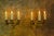 Pair of French Empire-style brass and bronze wall sconces, circa 1920. Elegant three-light wall sconces featuring a...