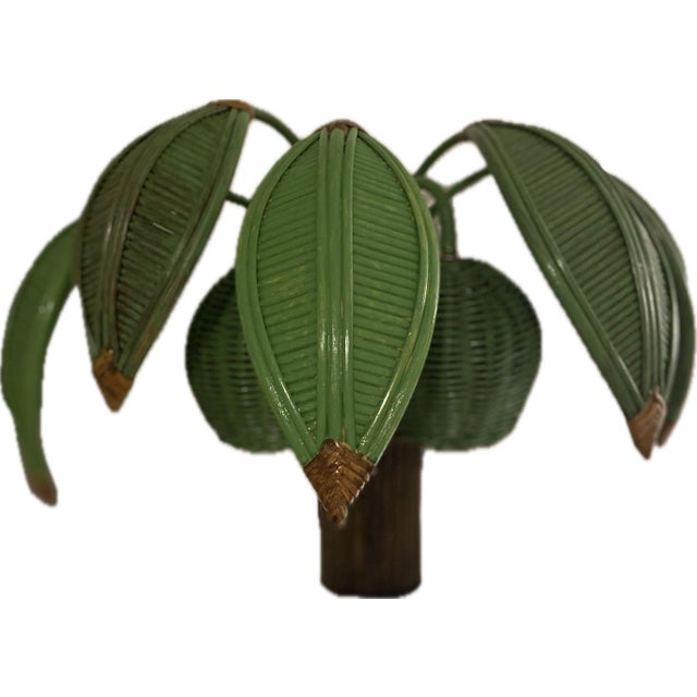 Offered is a beautiful pencil reed palm tree wall lamp attributed to Mario Torres Lopez. Two.coconuts conceal the lights....