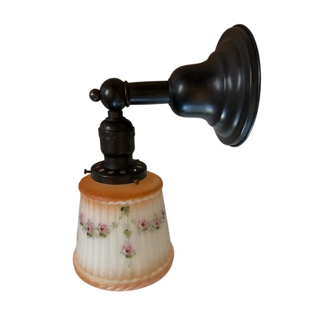 This is such a charming antique wall sconce. Perfect for a cottage or a penthouse! Fluted cast glass with original painted...