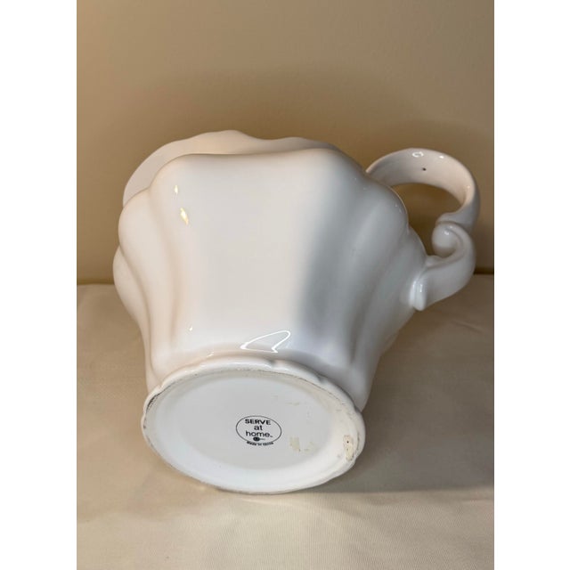 A beautifully sculpted, glossy white ceramic pitcher that perfectly captures a timeless, vintage-inspired look. Featuring...