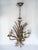 A gilt metal pendant light in the Hollywood Regency style by Hans Kögl, late 1960s/early 1970s. This five-light model...