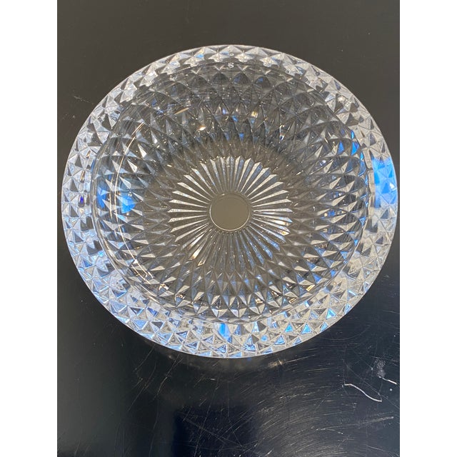 This exquisite crystal bowl, with its deep diamond-cut pattern and striking radiating center, is a masterpiece of light...