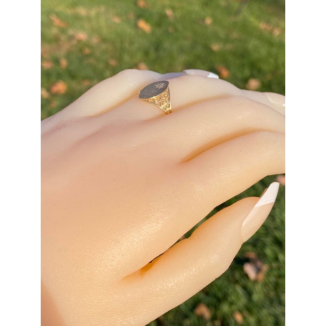 The 19th Avenue: Navette Shaped Signet Ring with Natural Diamond. The ring features a central off set round cut natural...