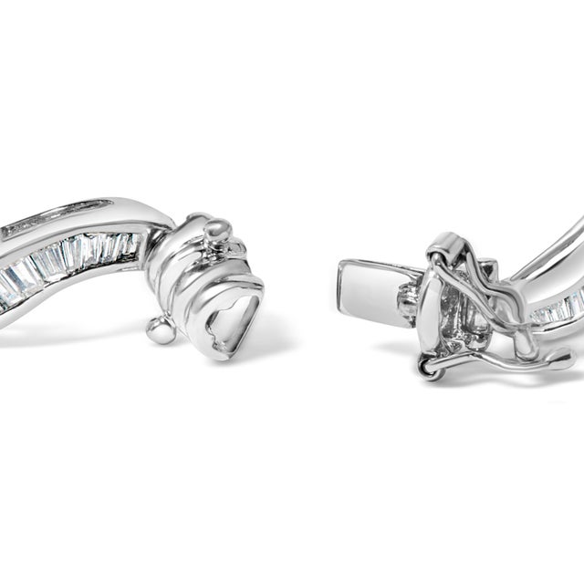 Indulge in the luxury of this breathtaking baguette-cut diamond channel link bracelet, crafted from 14K white gold. With...