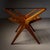 A stylish mid-20th century Italian side table featuring a smooth wood frame with a sleek glass top. The table's X-shaped...