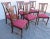 6 French Oak Carved Dining Chairs. Back carved with centerpiece of an urn with plumes. Red floral upholstered seats. Base...