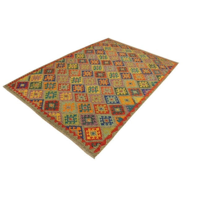 Add a touch of elegance to your home with this casual chic hand woven Tribal Kilim wool rug. Constructed on a loom by...