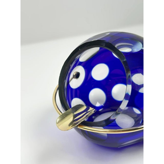 A striking cobalt blue cut-to-clear glass ashtray designed by marita voigt for veb glaswerk harzkristall, east germany,...