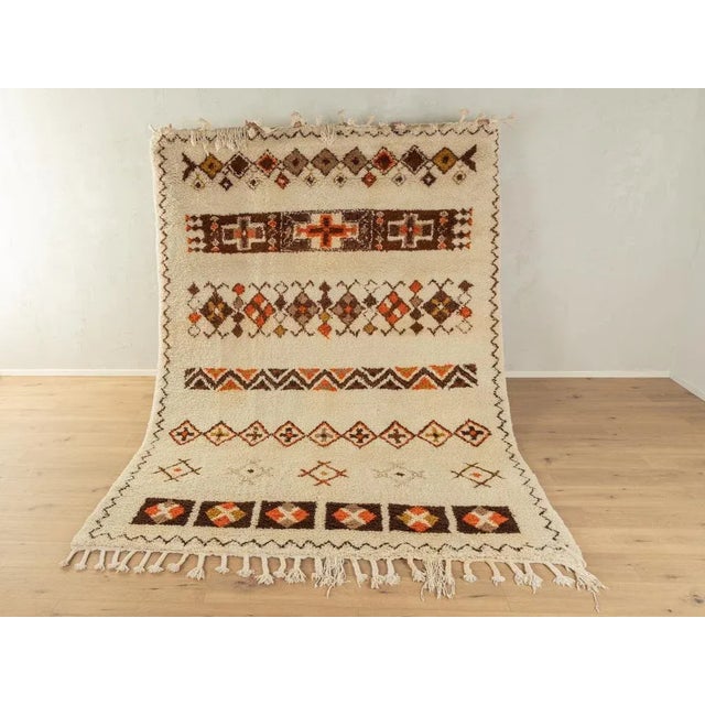 Wonderful Vintage Berber rug with long fringes from the 1960s. Wonderful cream white pile with patterns in brown, orange...