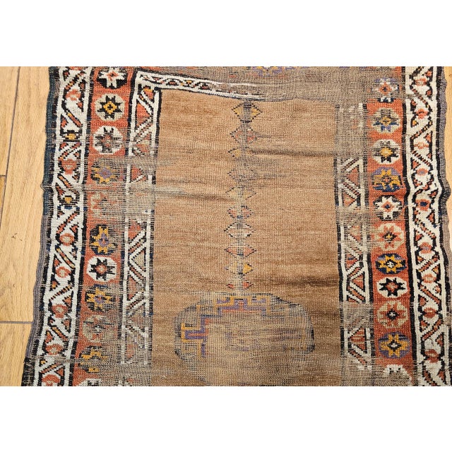 "This striking antique Kurdish camelhair runner, woven in the late 19th century, embodies the refined simplicity and...