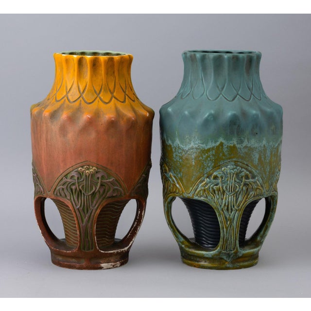 Pair of Art Nouveau-style vases in majolica ceramic with polychrome glazes, creating a dripping and iridescent effect....
