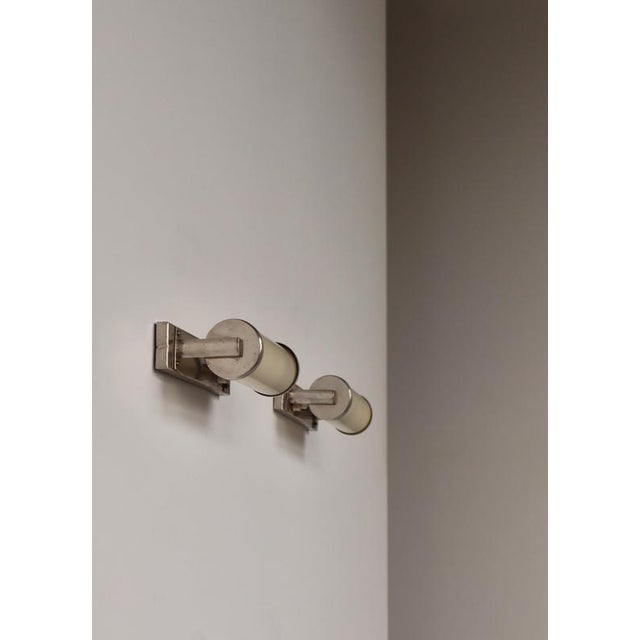 Rare and elegant pair of 1930s Swedish Art Deco wall lamps by ASEA, featuring streamlined chrome-plated metal mounts and...