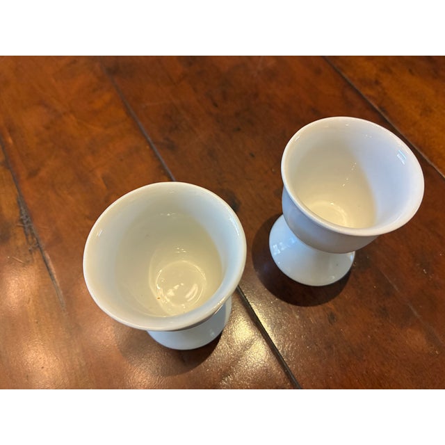 Cute pair of white china egg cups. No markings.