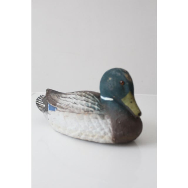 A vintage Carry Lite mallard duck decoy with a grounded, sculptural form and a time-worn painted surface that reflects its...