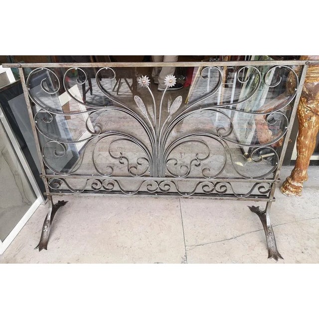 Forged iron firescreen with glass protection.