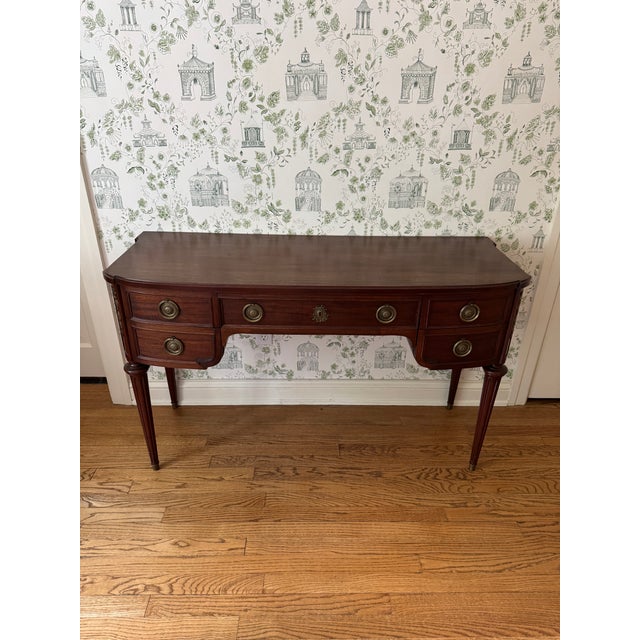 Stunning John Widdicomb Mahogany writing desk featuring a serpentine front, brass pulls, detailed gold floral appliqués on...