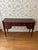 Stunning John Widdicomb Mahogany writing desk featuring a serpentine front, brass pulls, detailed gold floral appliqués on...