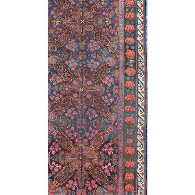 Antique Caucasian 19th Century Seychour Rug in Blue, Green, Brown & Multi Colors. Set on an indigo background this antique...
