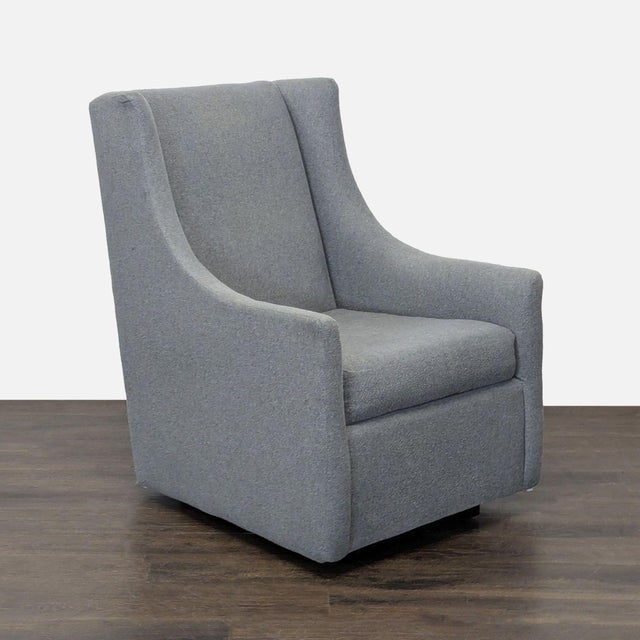 This West Elm rocking lounge chair offers a modern look with clean lines and a soft gray fabric. The sturdy build and...