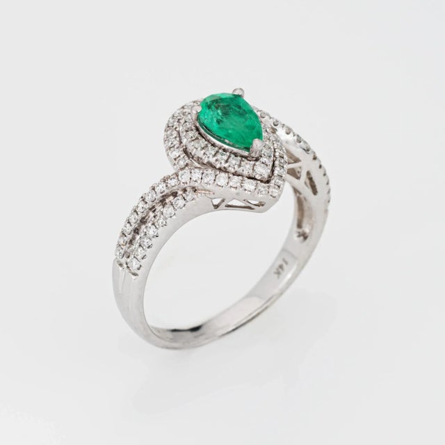 Stylish emerald & diamond ring crafted in 14 karat white gold. Pear cut emerald is estimated at 0.40 carats. Diamonds...