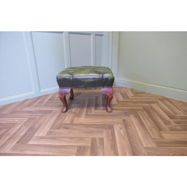 Walnut & Leather Chesterfield Library Stool. The stool is upholstered with deeply buttoned green leather, it set on hefty...