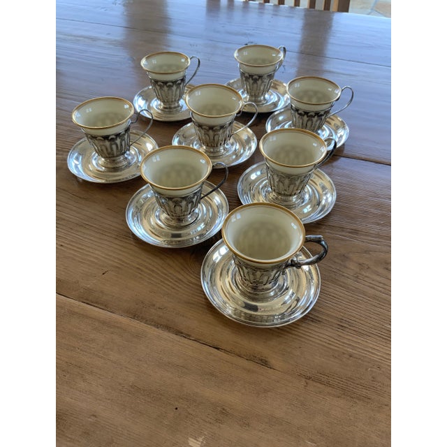 Lovely elegant set of eight gilt-rimmed cream-colored Lenox porcelain demitasse cups with sterling silver Wilcox and...